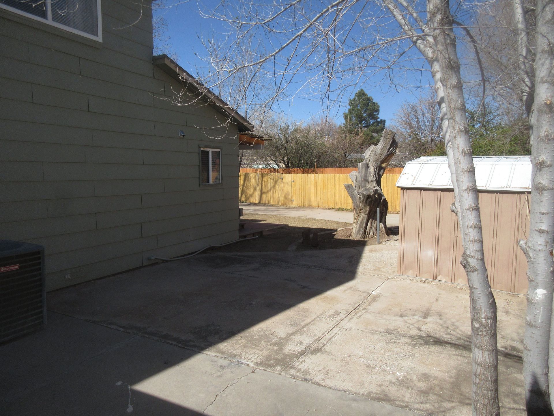 There is a shed in the backyard of a house.