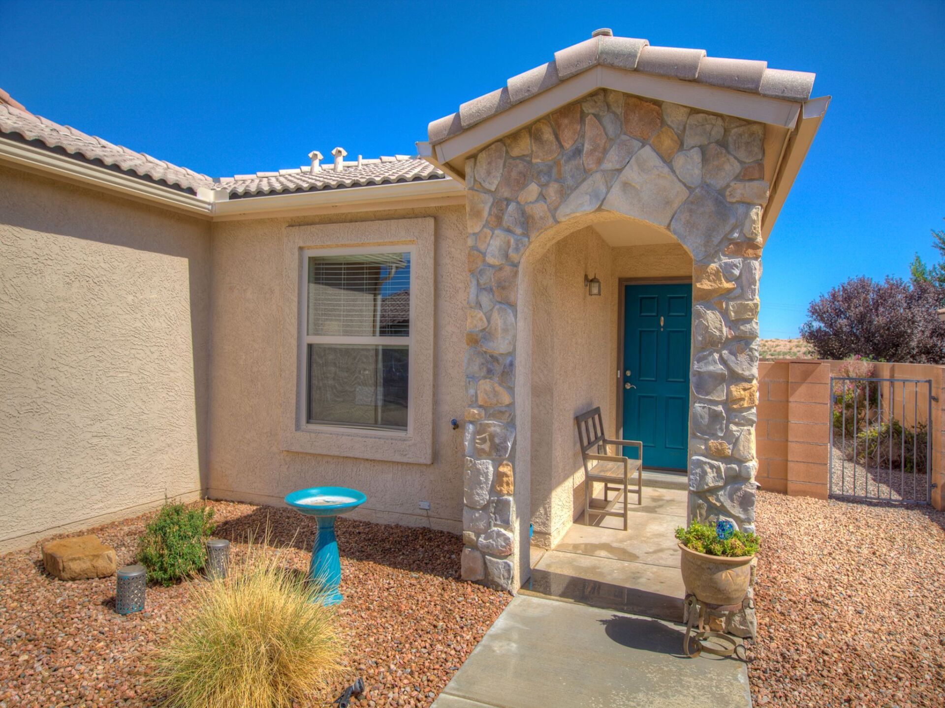 A house with a blue door and a stone porch