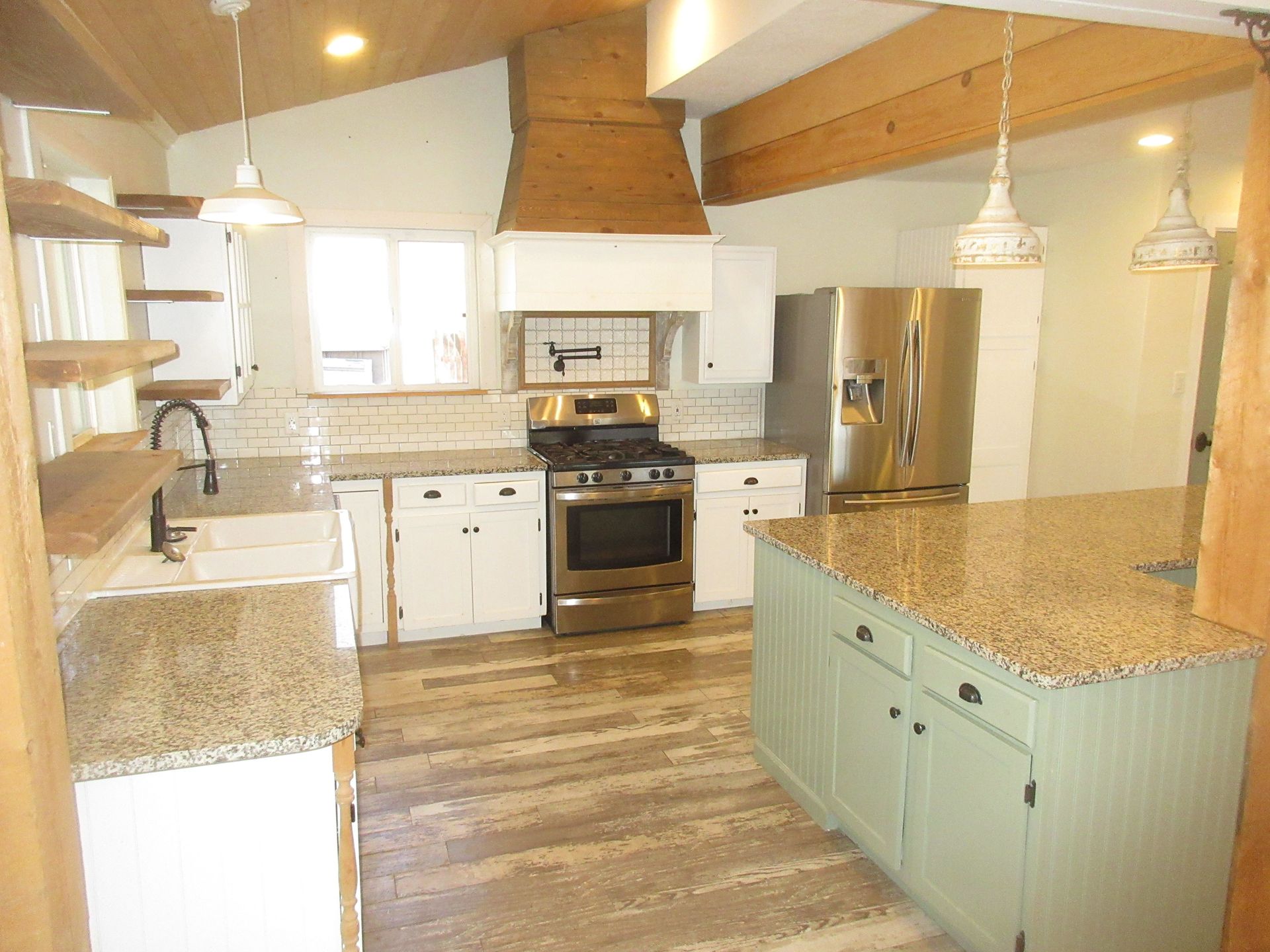 A kitchen with stainless steel appliances and granite counter tops