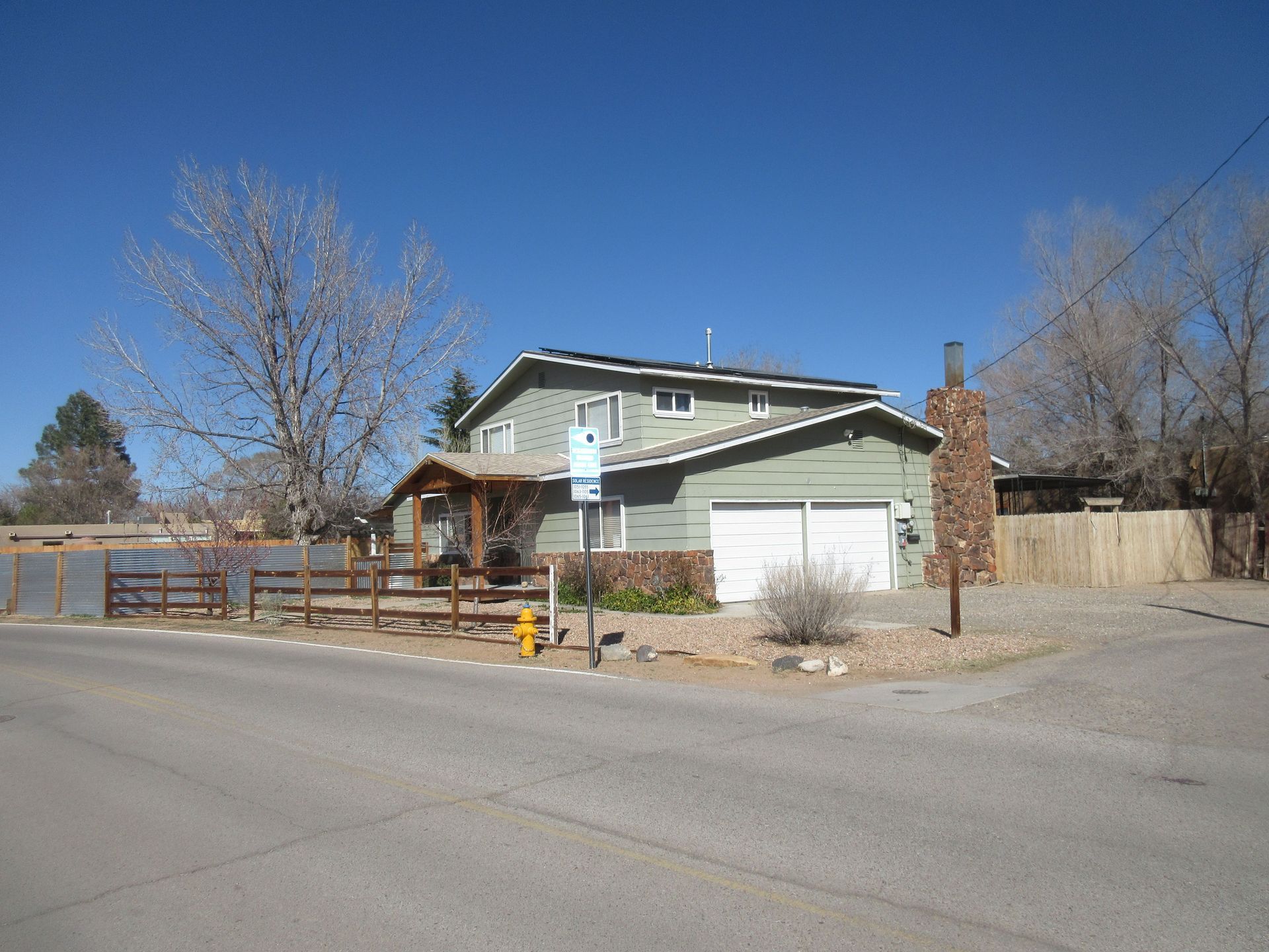 A house with a fire hydrant in front of it