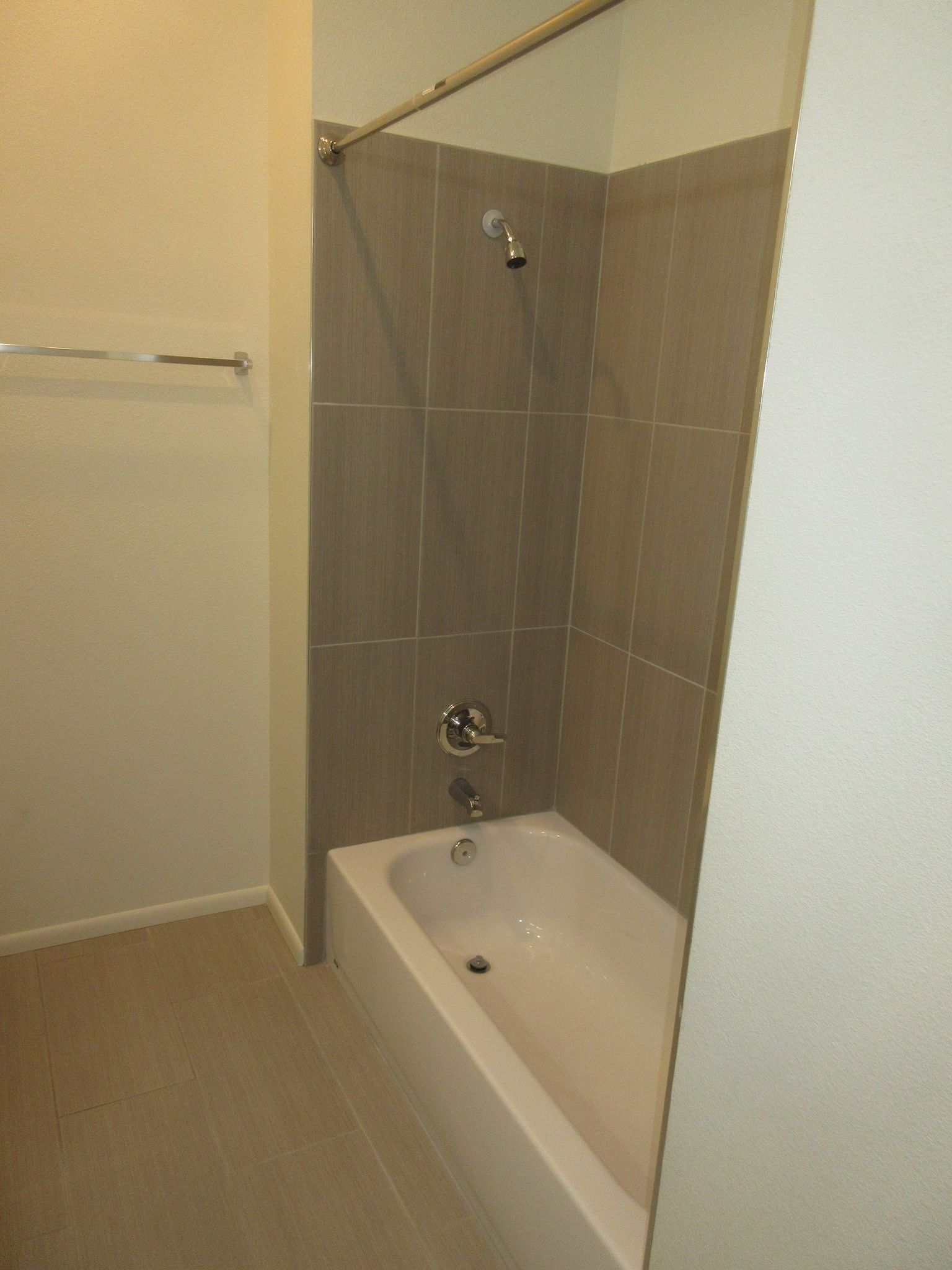 A bathroom with a bathtub and a shower.