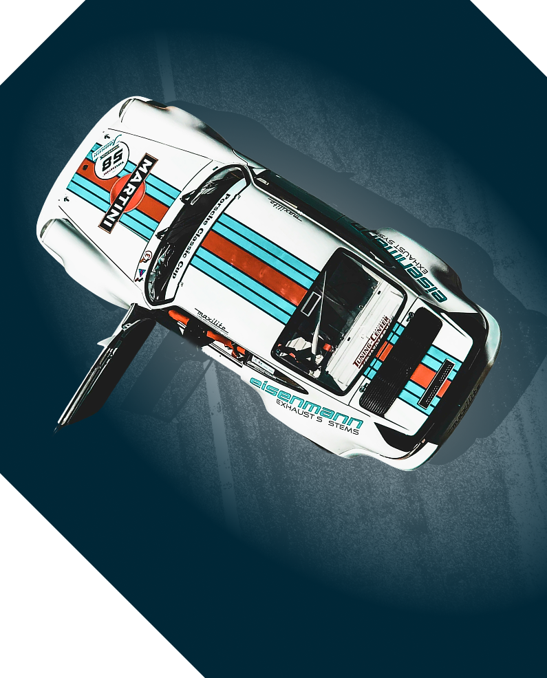 White Porsche race car, Martini livery, parked, on blue-gray surface.