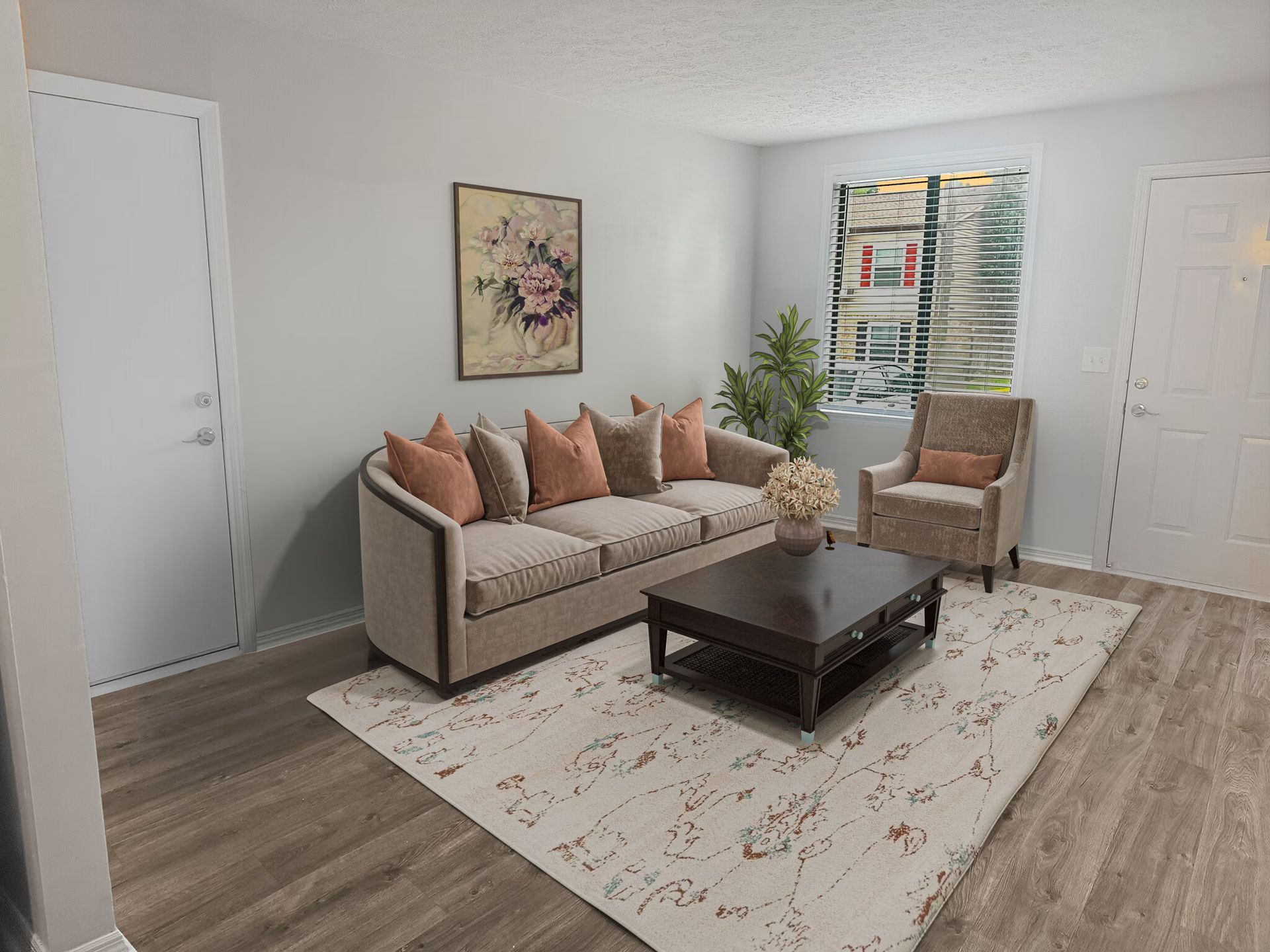 Living room with sofa, armchair, rug, and coffee table. Neutral colors and natural light at  Glastonbury Woods Apartments.