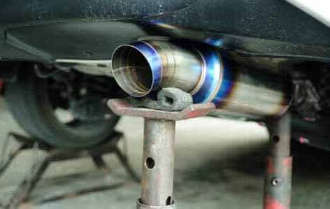 Car Changing New Exhaust Pipe on Tripod Hand Jack— Bro Muffler & Auto Repair in Huntington Beach, CA