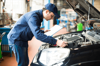 Mechanic at Work in his Garage — Bro Muffler & Auto Repair in Huntington Beach, CA Mechanic at Work in his Garage — Bro Muffler & Auto Repair in Huntington Beach, CA