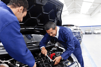 Two Mechanics Fixing a Car — Bro Muffler & Auto Repair in Huntington Beach, CA Two Mechanics Fixing a Car — Bro Muffler & Auto Repair in Huntington Beach, CA
