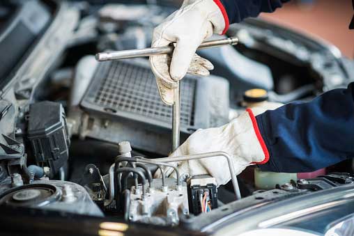 Detail of a Mechanic at Work on Car Engine — Bro Muffler & Auto Repair in Huntington Beach, CA