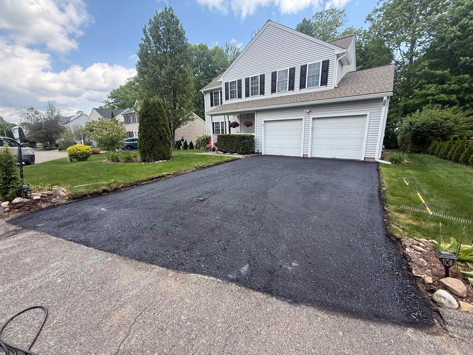 Freshly graded screened asphalt millings driveway