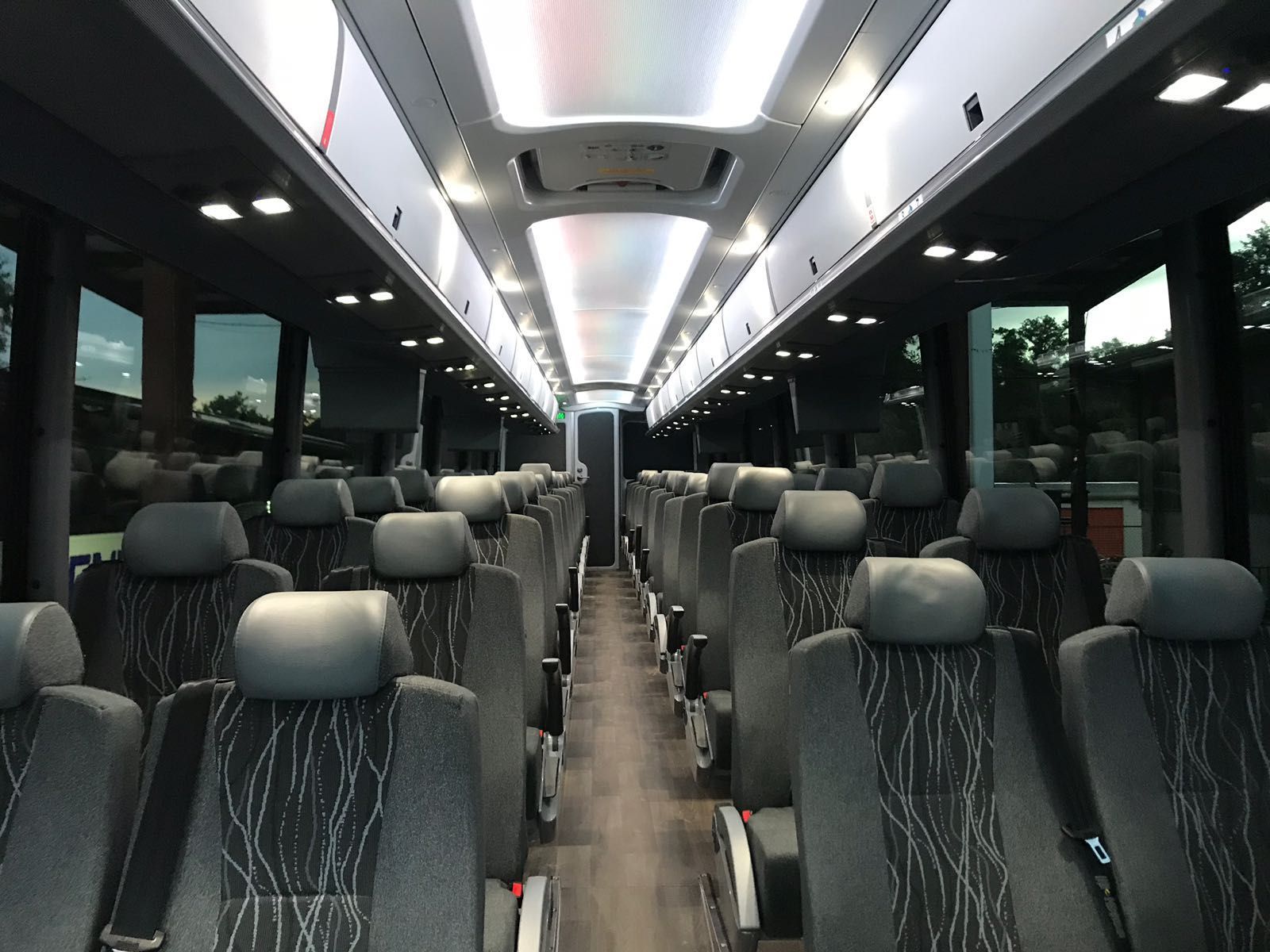 Premium coach bus interior for private group travel and concierge driver service in Atlanta
