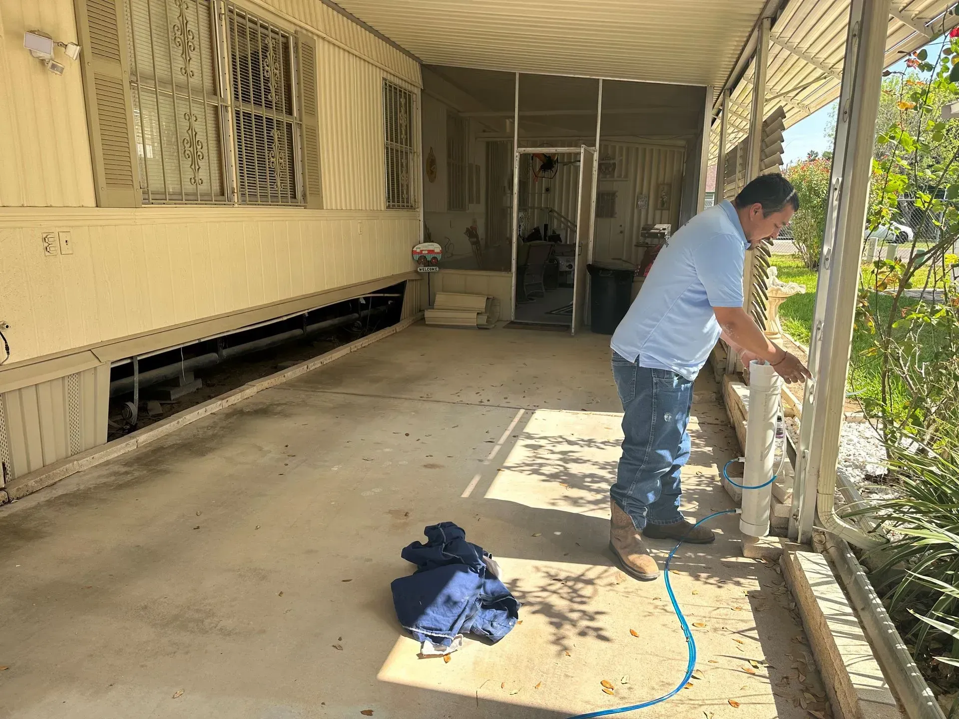 a man is working on a porch of a mobile home