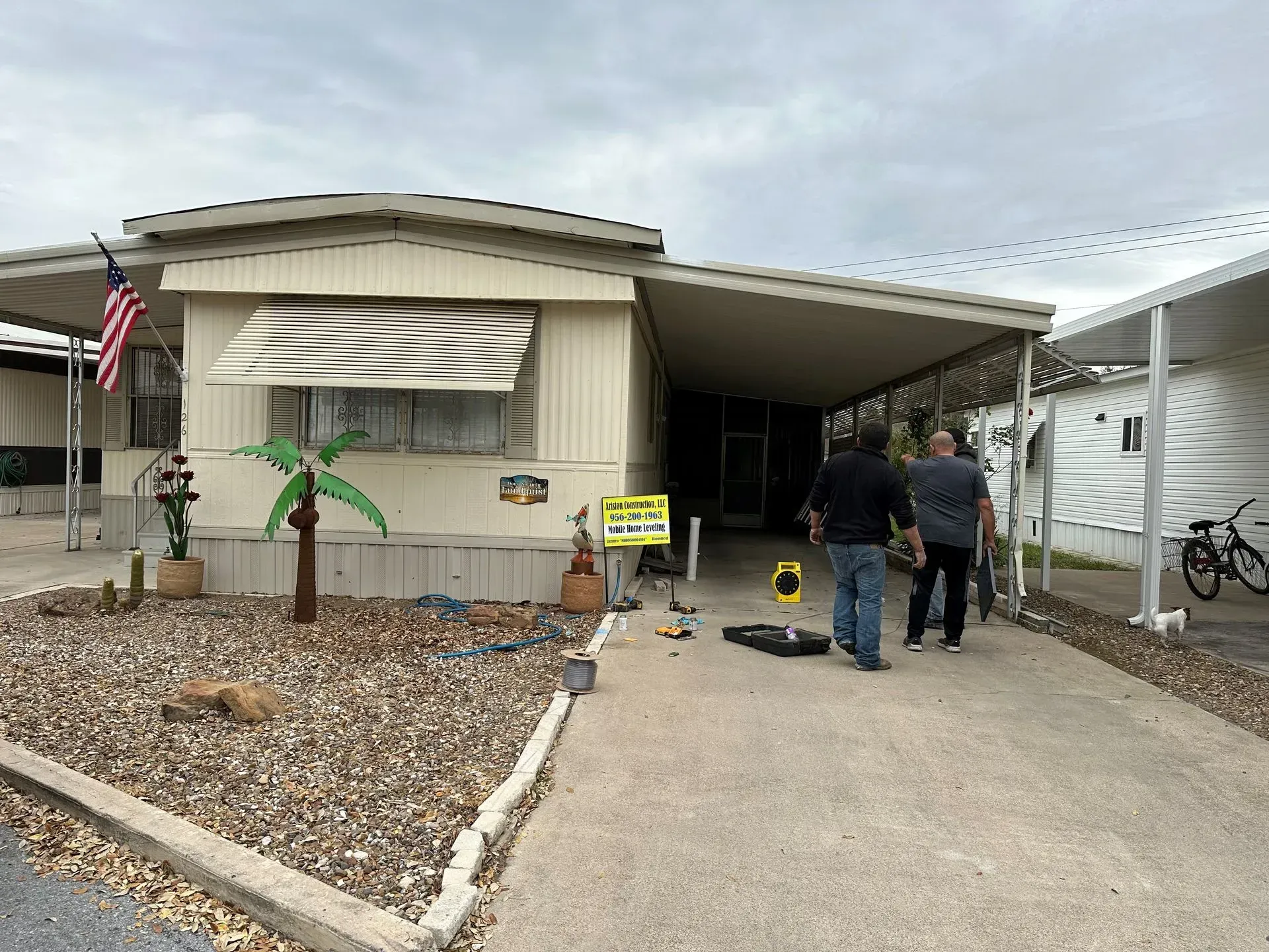 a group of people are standing in front of a mobile home