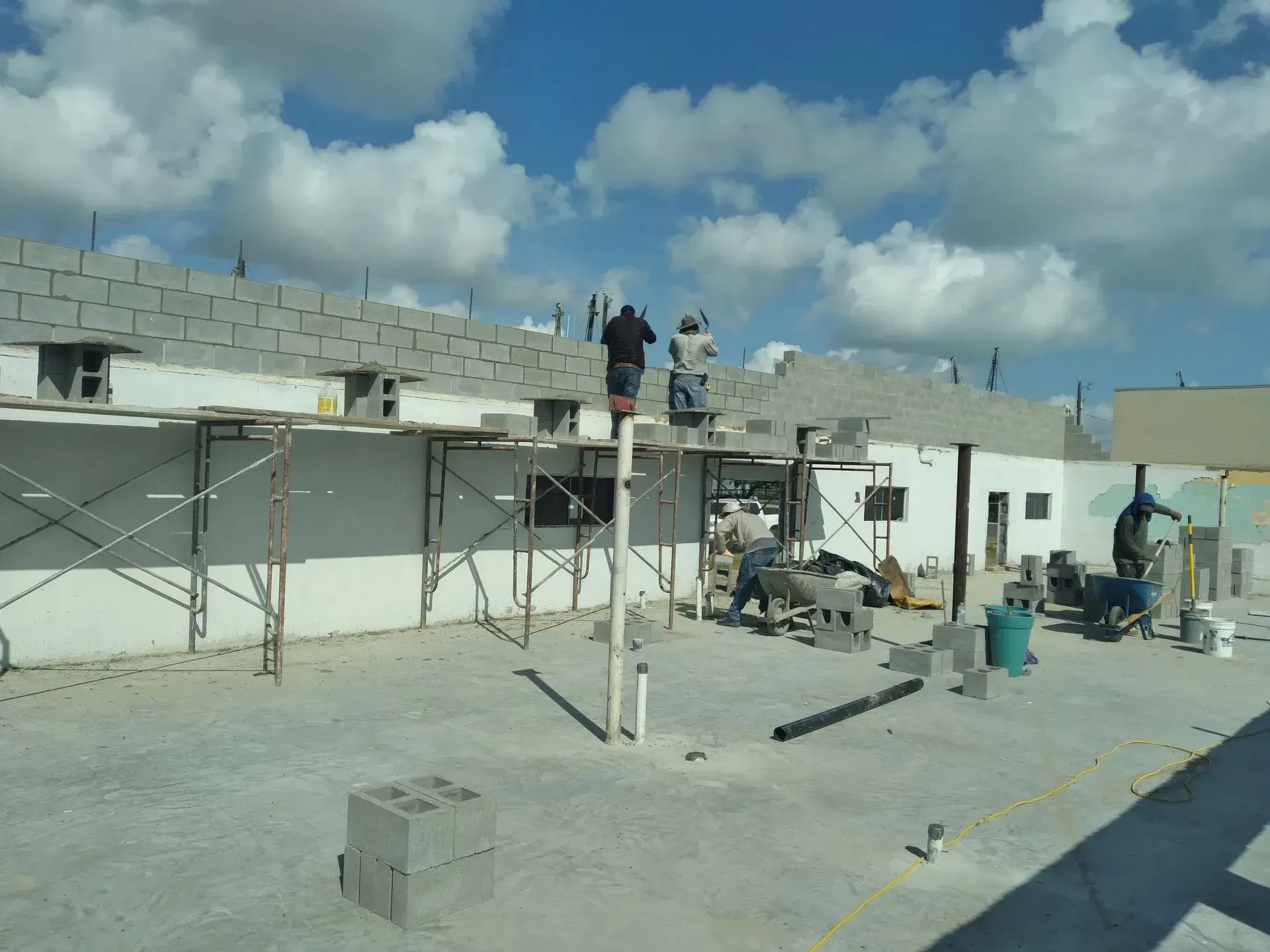 a group of construction workers are working on a building