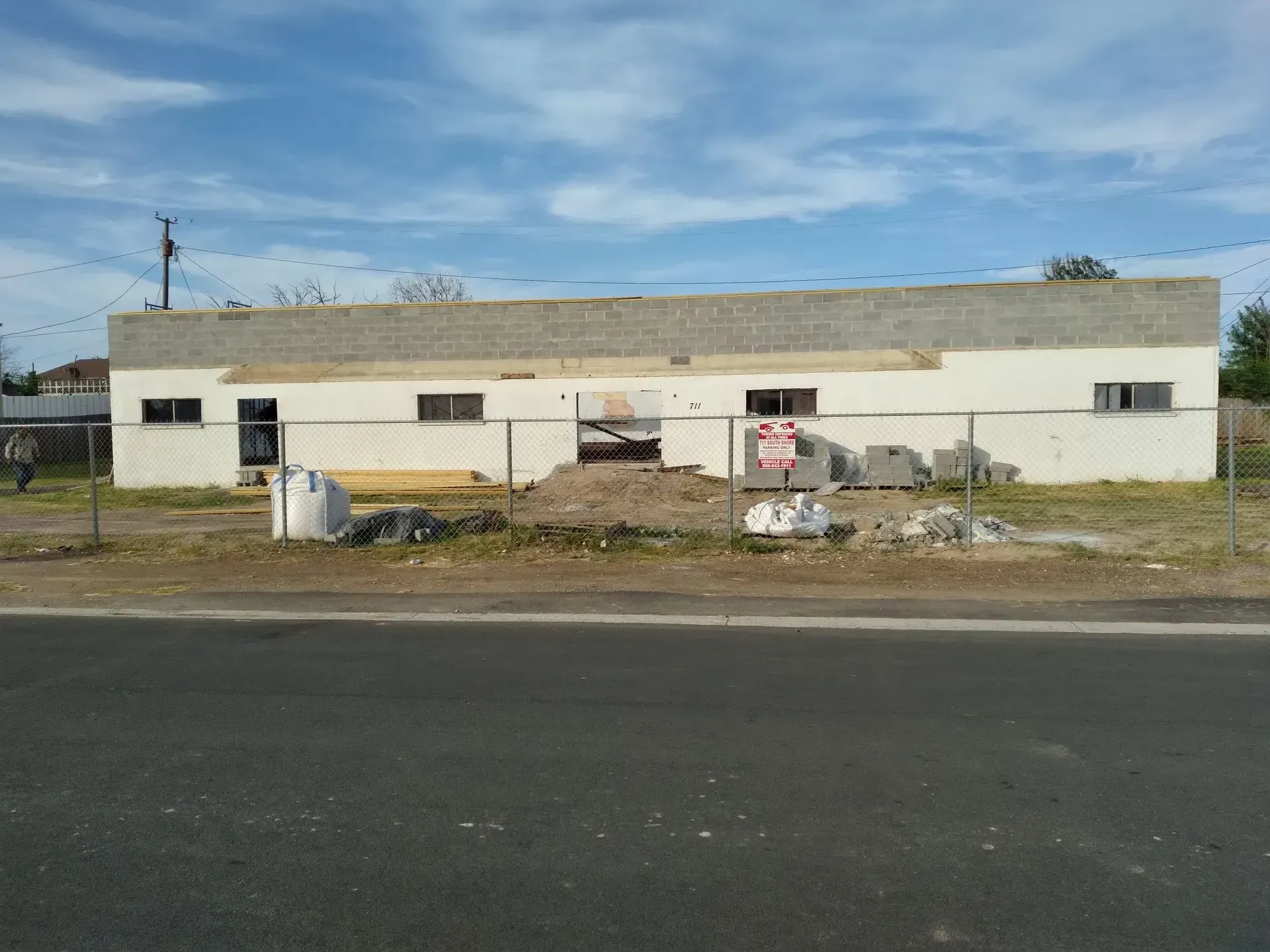 a large white building with a no parking sign in front of it