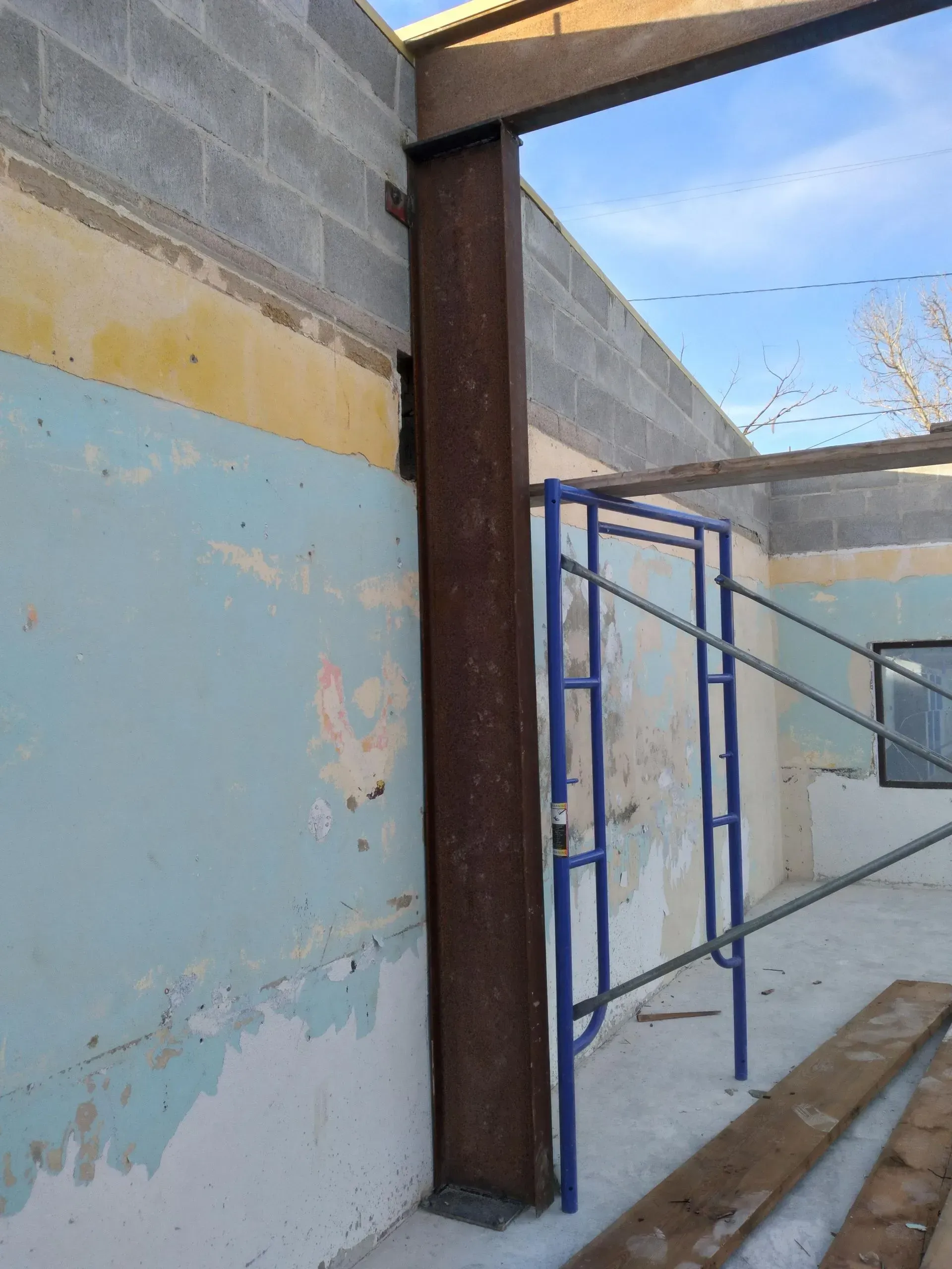 a building under construction with a scaffolding in front of it