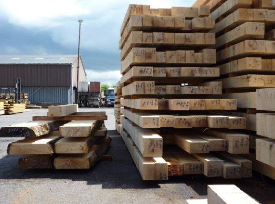 large stack of timber outside in a yard