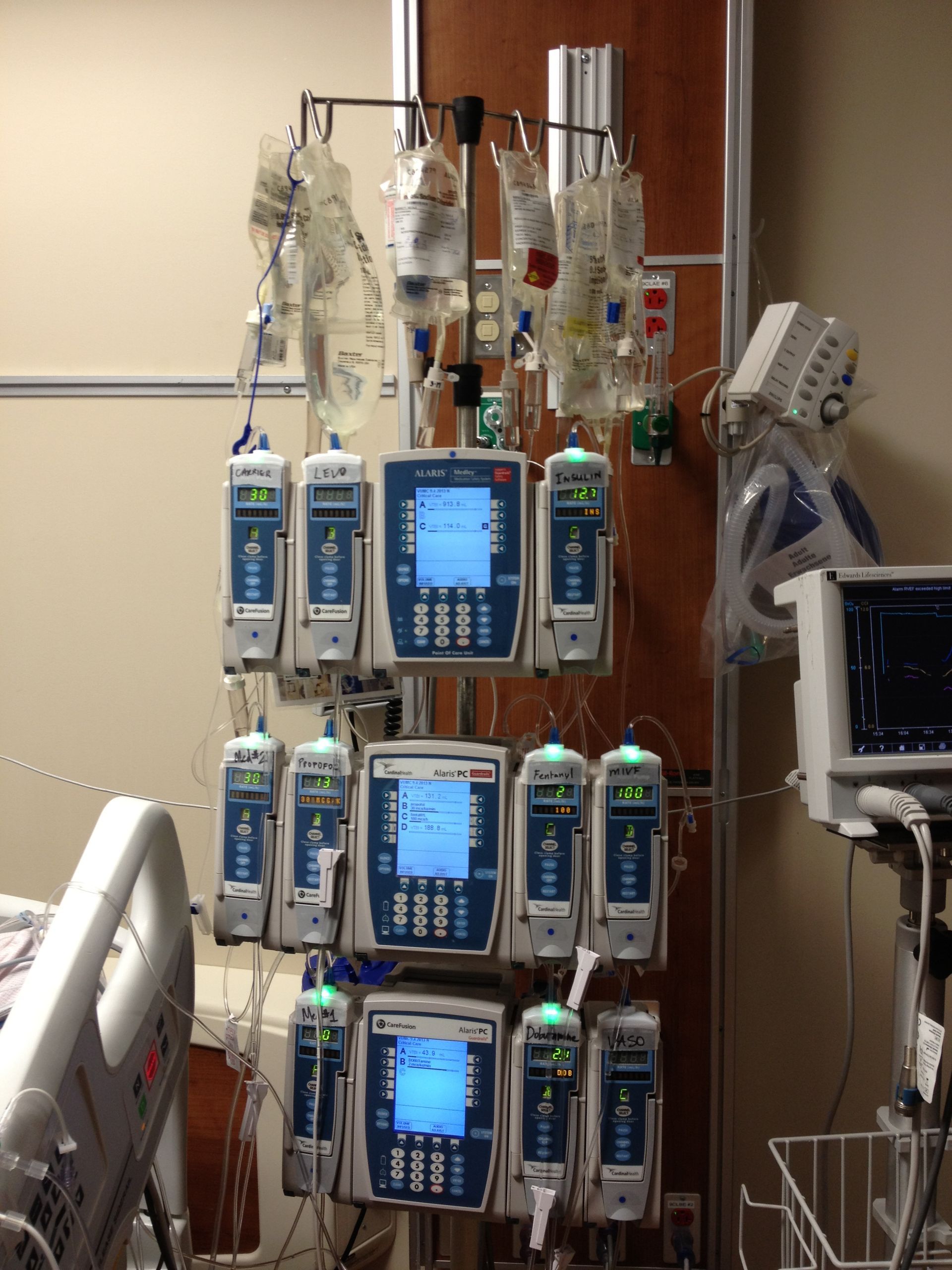 A hospital room with a bed and a bunch of medical equipment