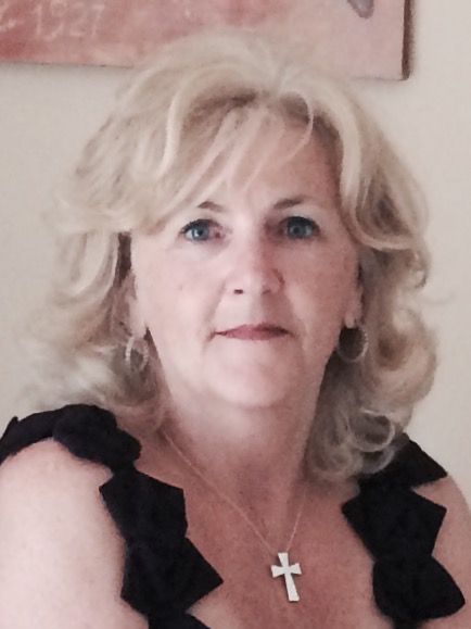 A woman wearing a black top and a cross necklace