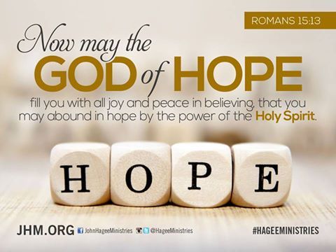 A bible verse from romans 15:13 is written on wooden cubes.