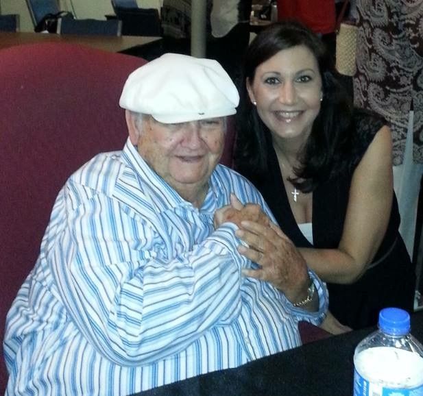 A man wearing a white hat is sitting next to a woman