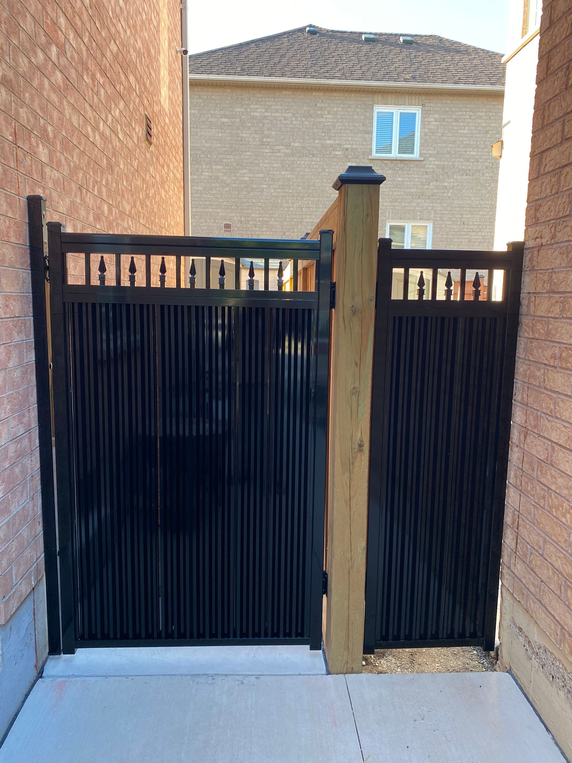 A custom-made aluminum gate adorns a home and enhances curb appeal.