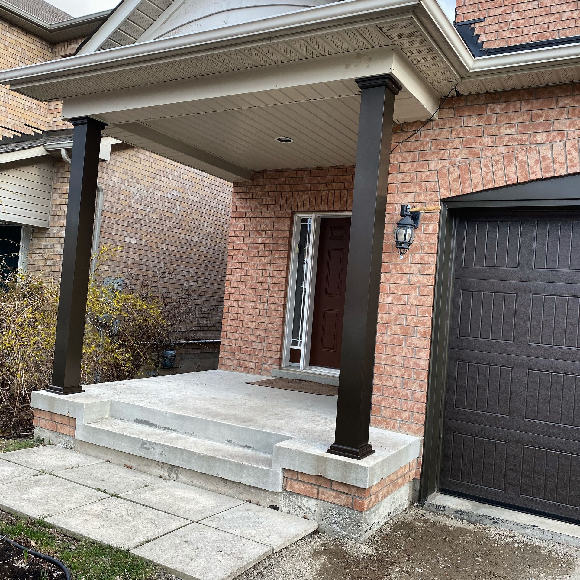 A brick house with a porch and stairs