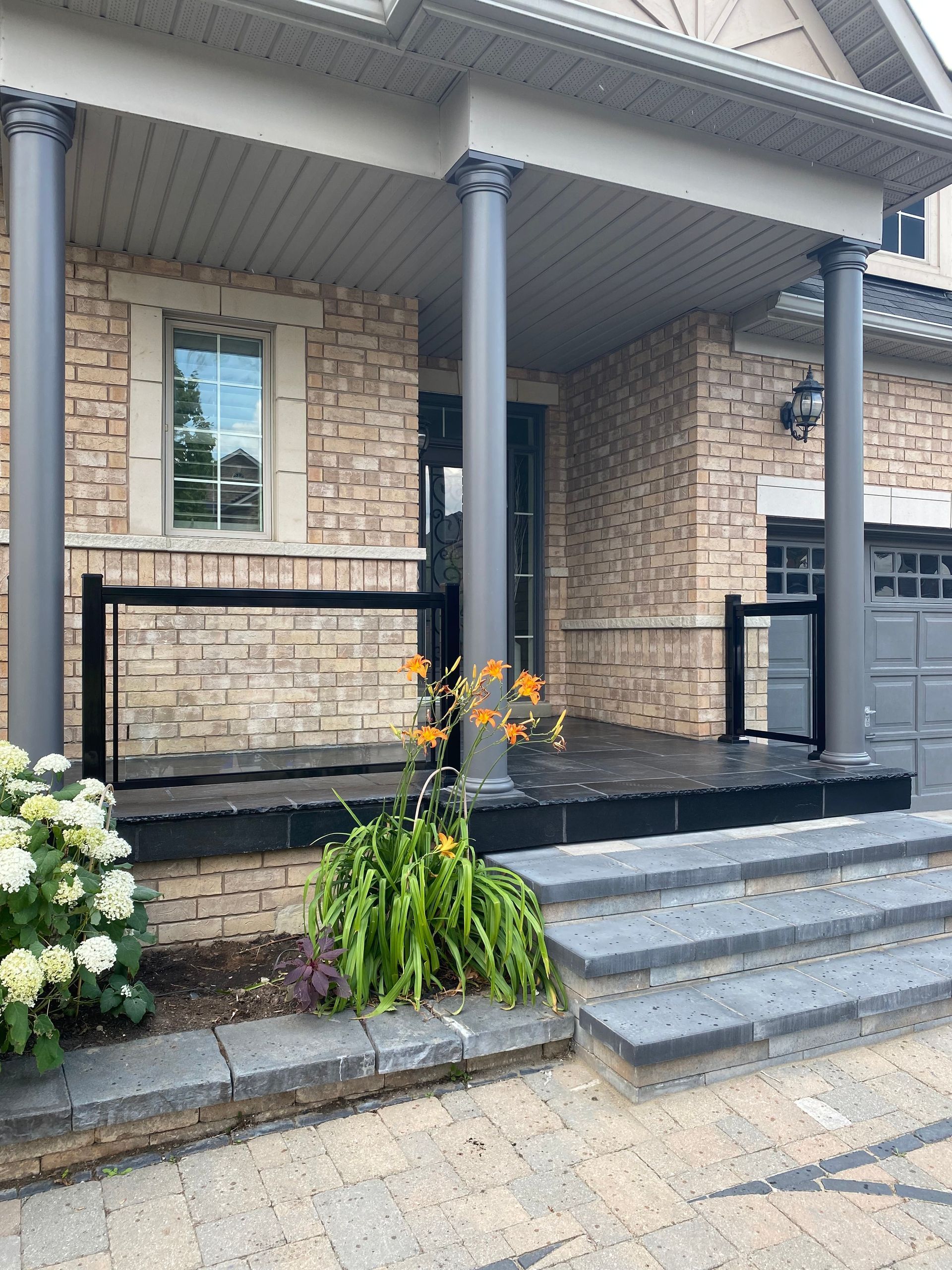 A brick house with a porch and stairs