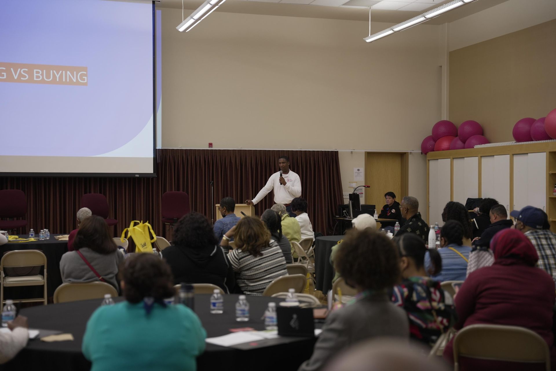A man is giving a presentation to a group of people in a room.
