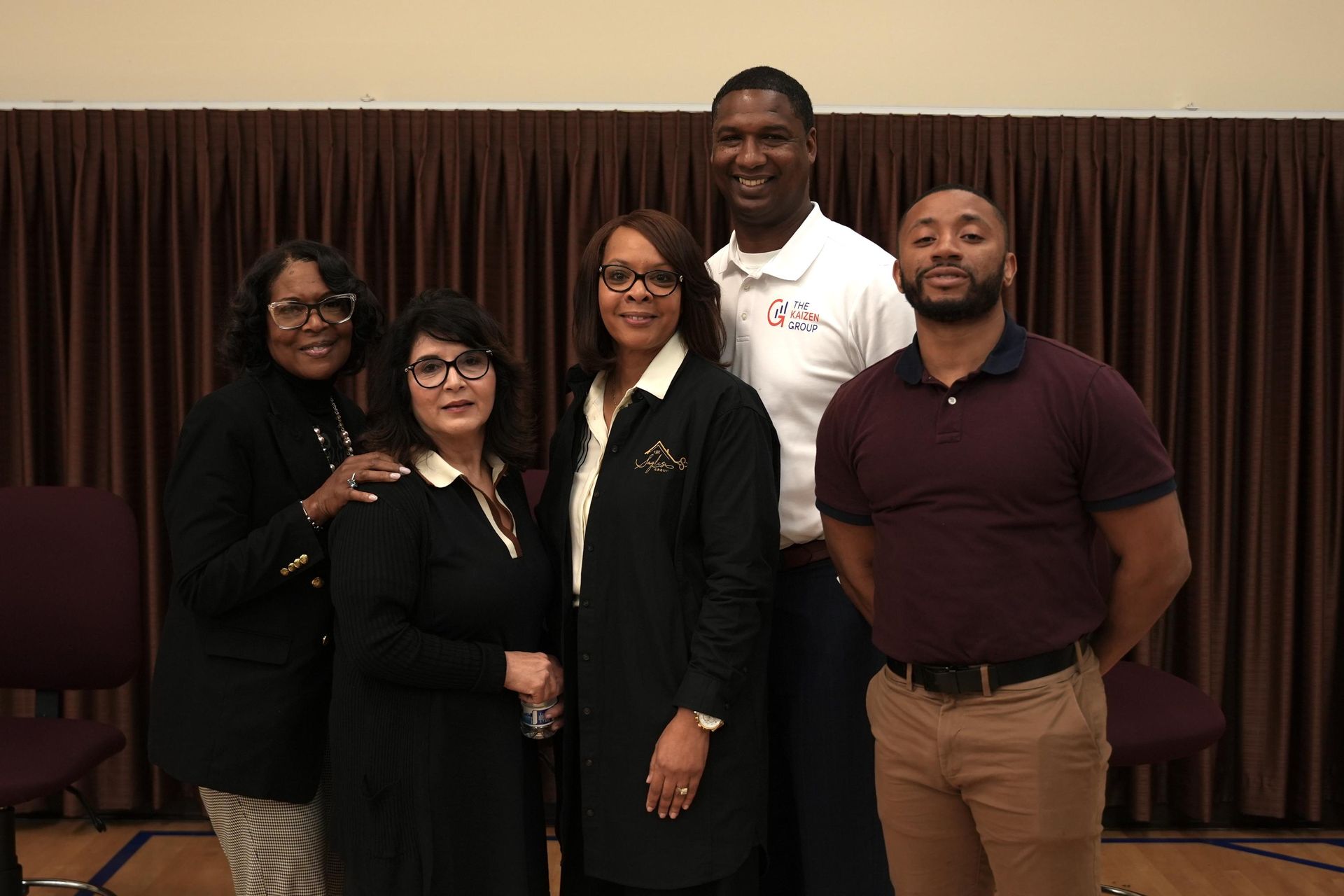 A group of people are posing for a picture in a room.