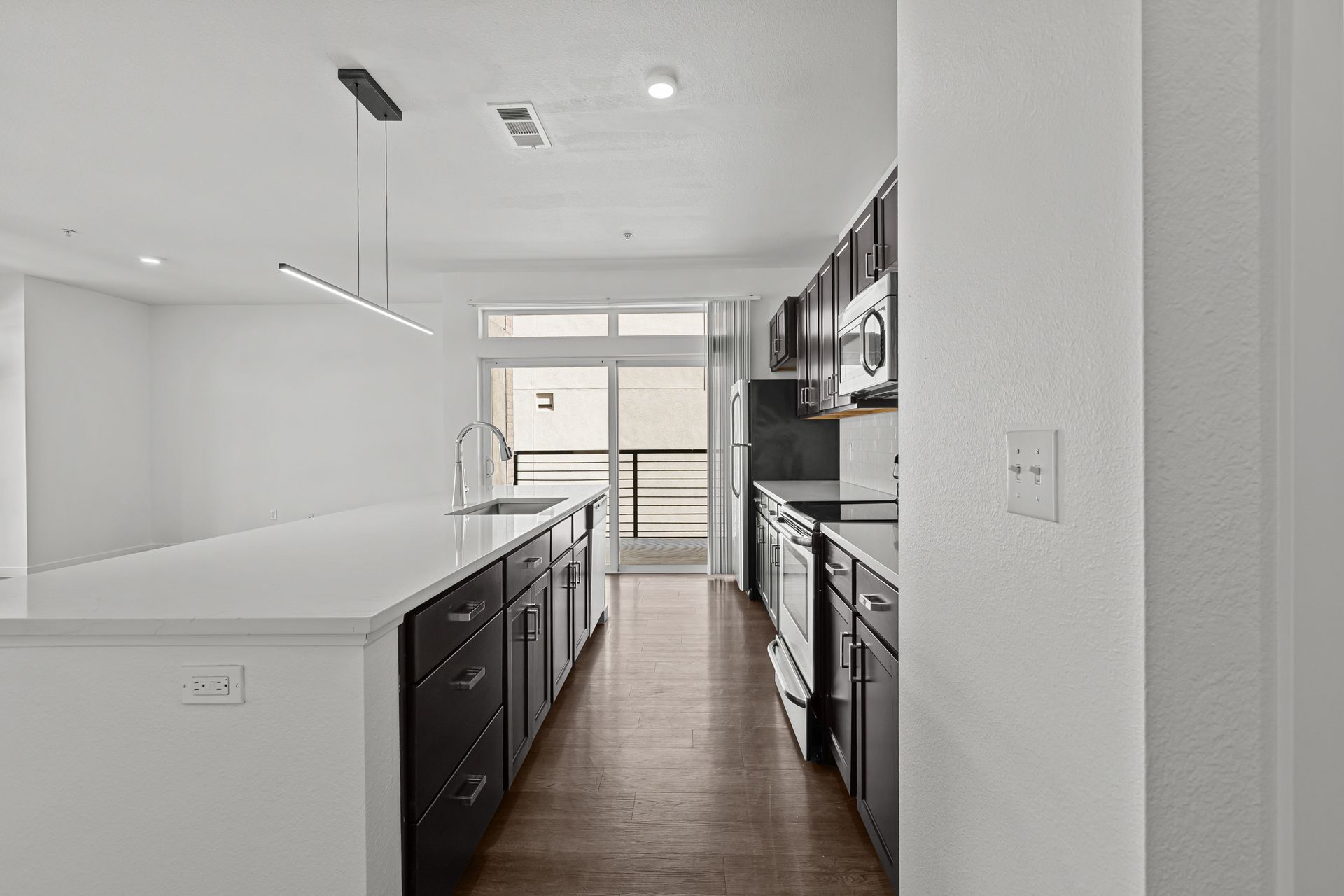 A kitchen with a large island in the middle of the room.