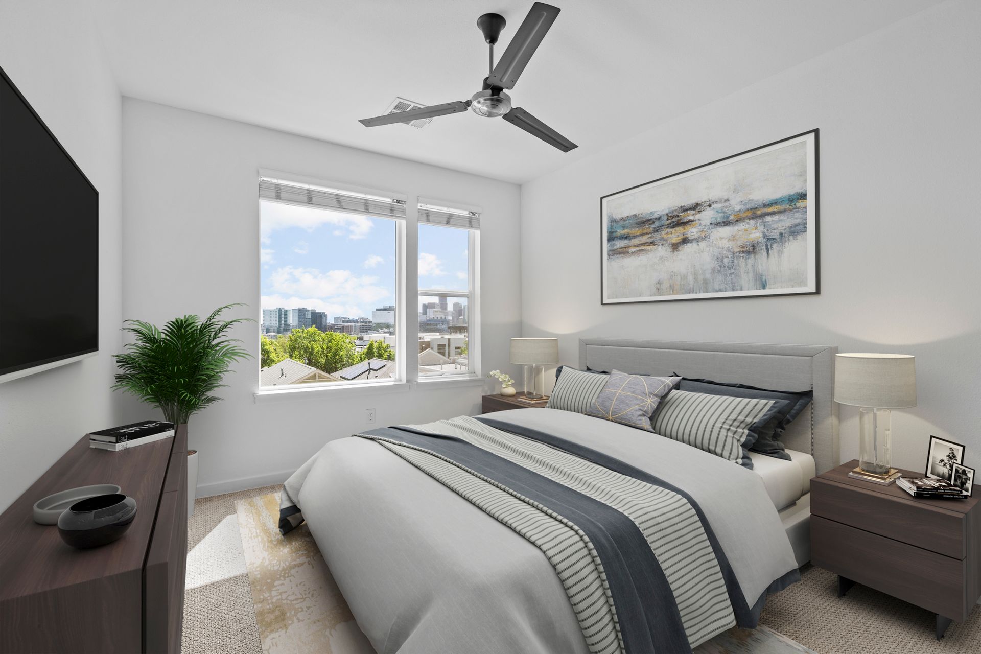 A bedroom with a large bed and a ceiling fan