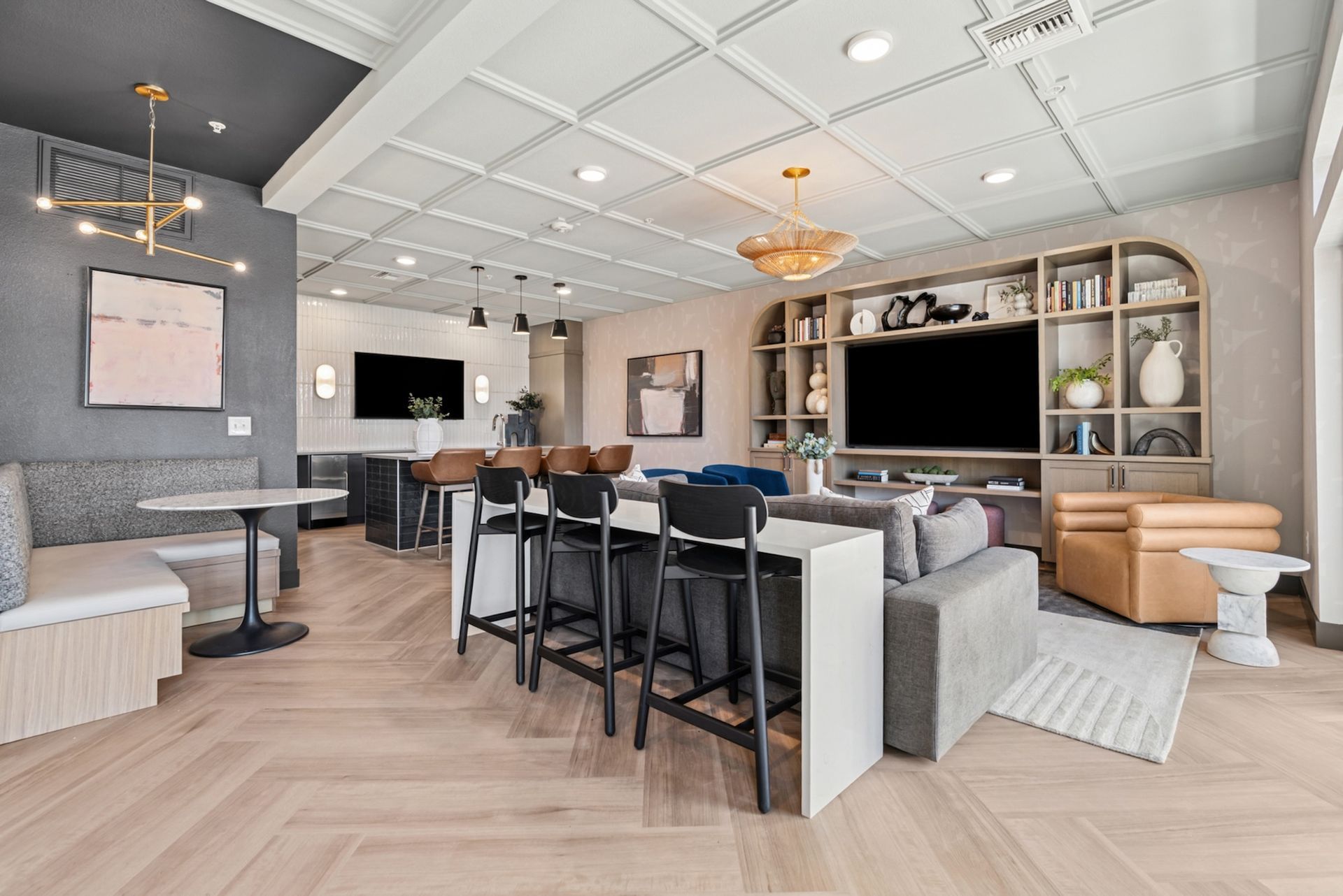 Modern lounge with seating, bar, TV, and decorative ceiling.