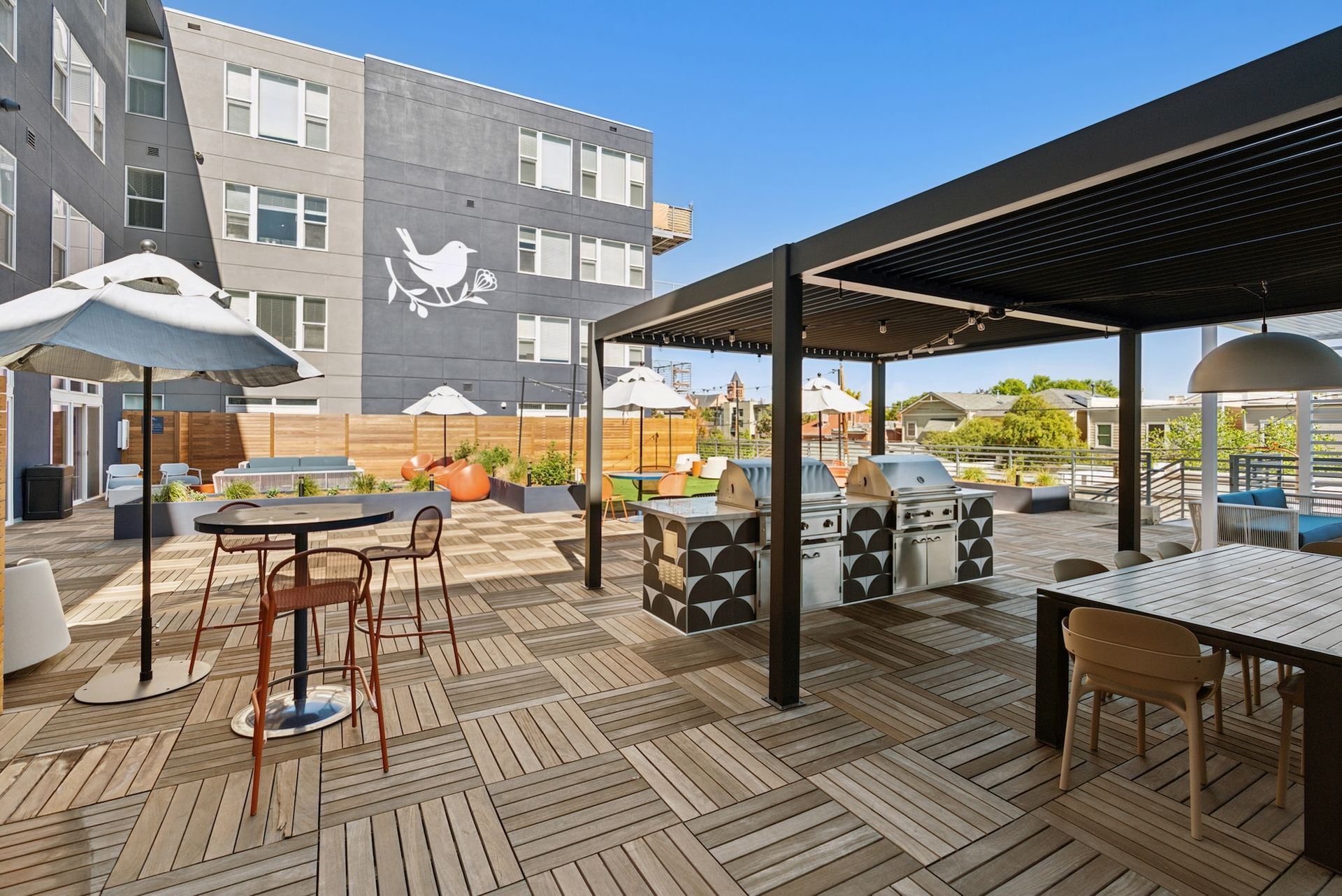 An artist 's impression of a patio area with tables and chairs in front of a building.