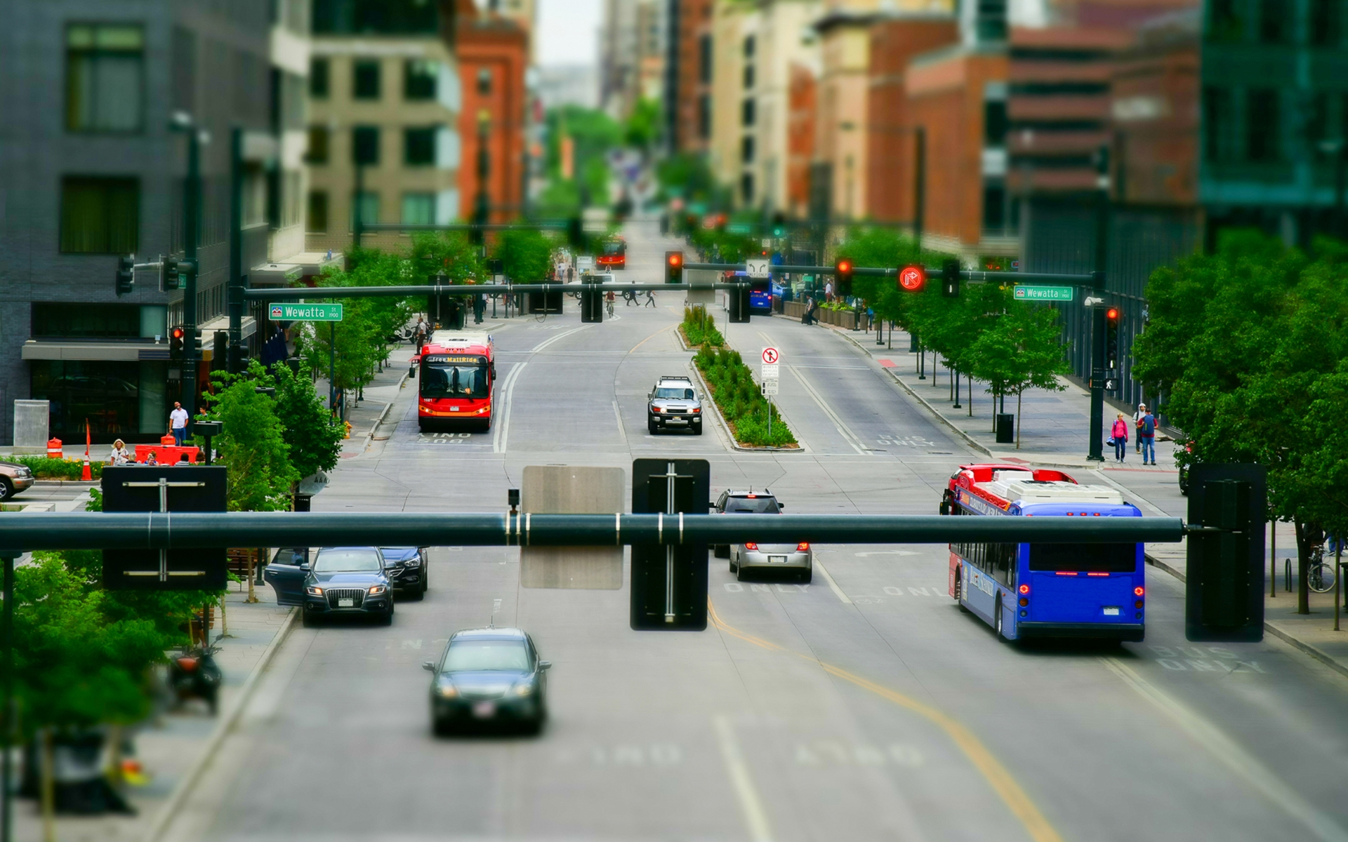 A blurry picture of a city street with cars and buses driving down it.