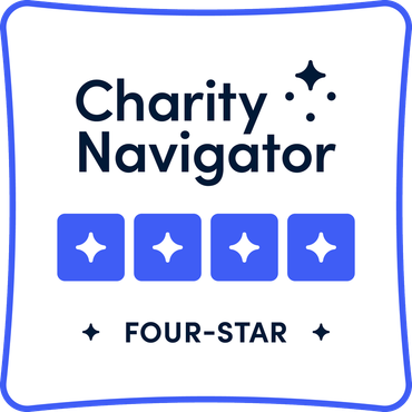 Charity Navigator Four-Star rating badge with text and four blue squares with stars on a white background, outlined in blue.
