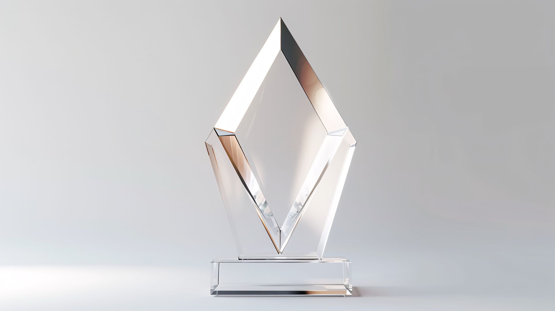 Crystal trophy with diamond shape and clear base on white background.