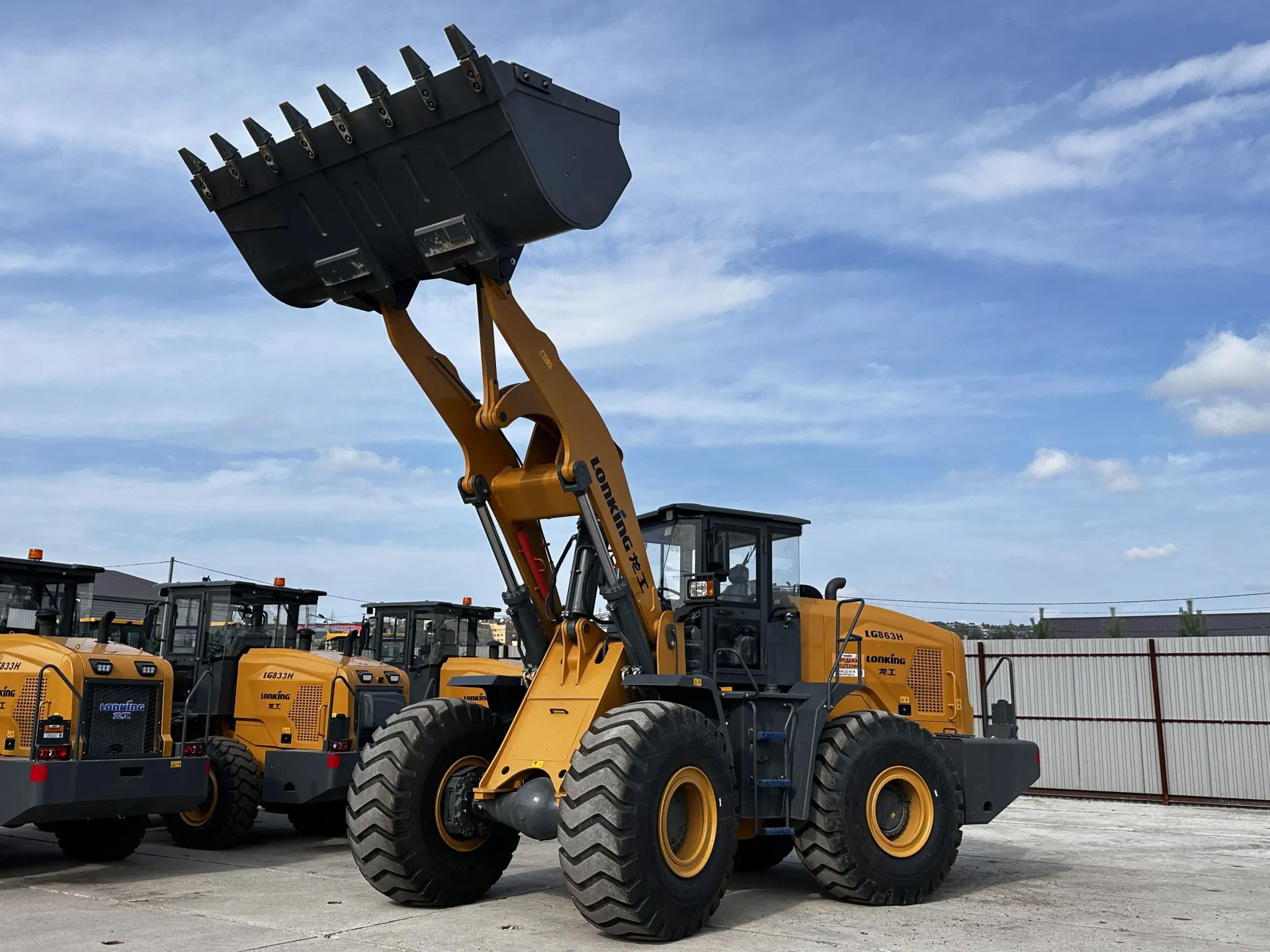 Yellow Lonking front-end wheel loader with raised bucket at Vibranium Machinery outdoor yard Dubai UAE
