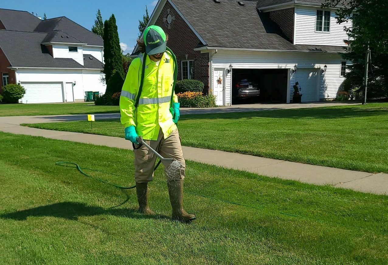 Turftenders Inc Employee Performing Seasonal Lawn Applications in Cheektowaga, NY