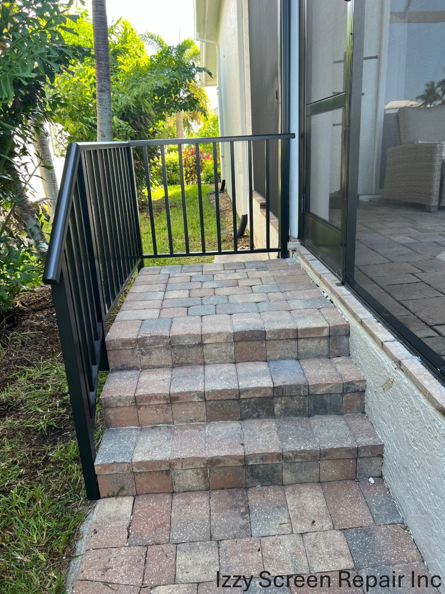 A set of stairs leading up to a screened in porch