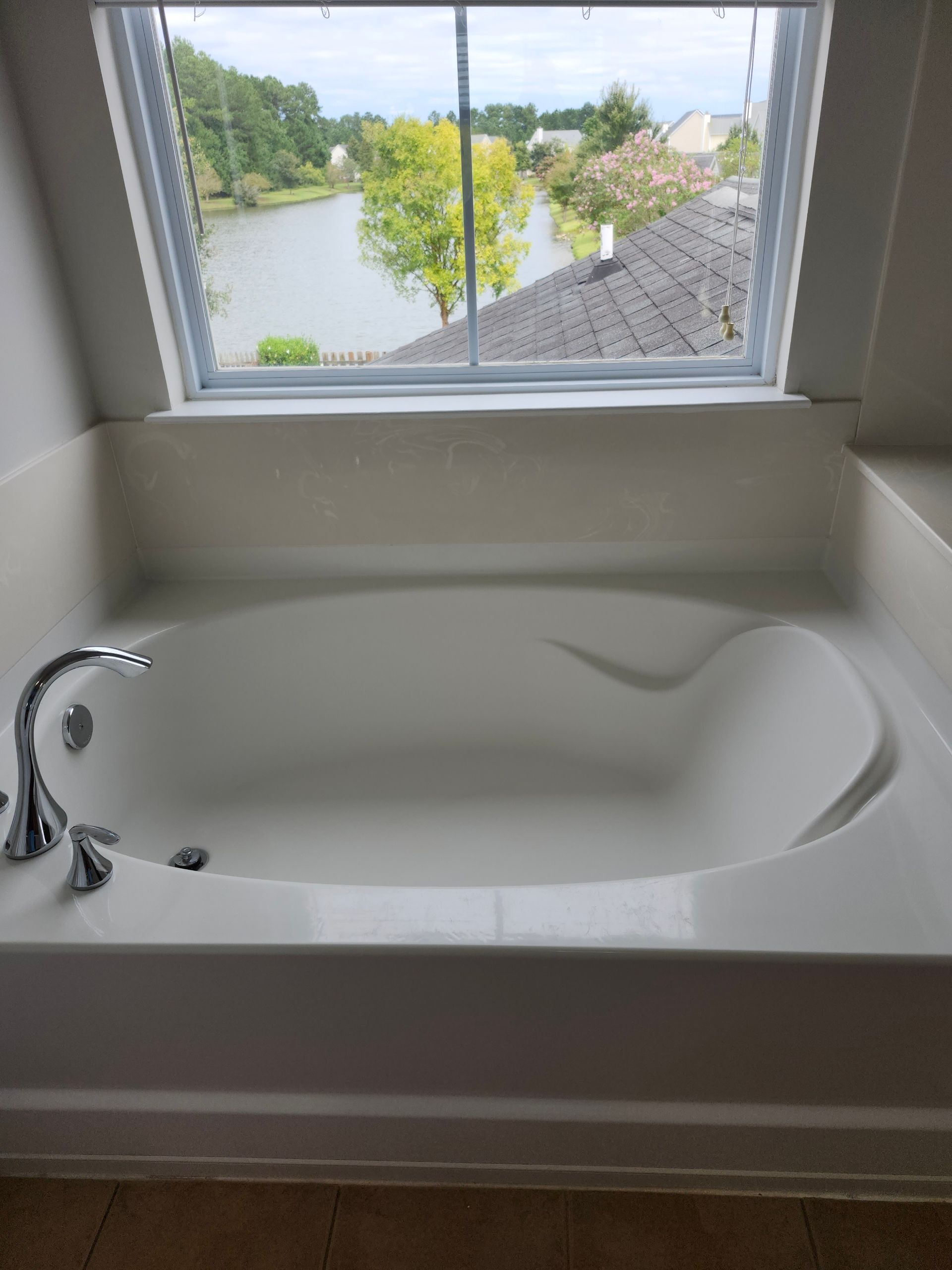 A man is cleaning a window with a squeegee.