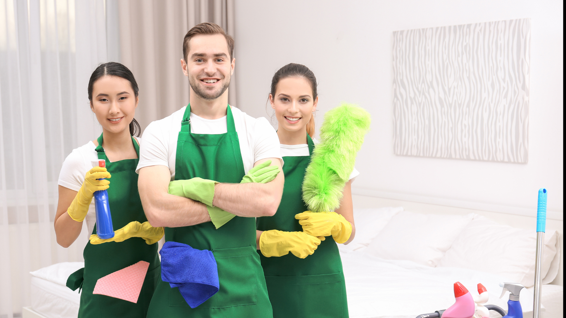 A group of cleaners are posing for a picture in a living room.