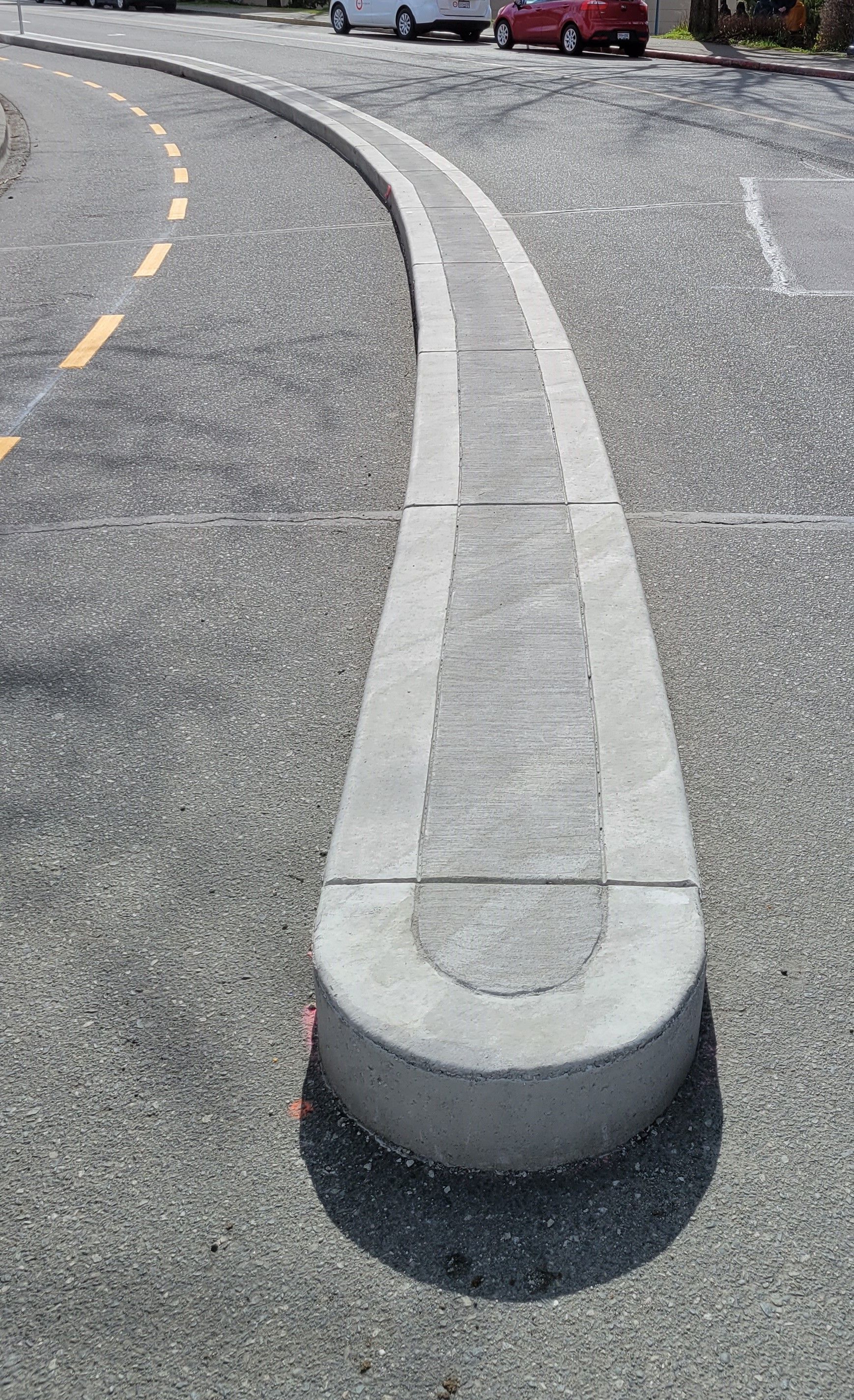 Concrete curb separating bike lane