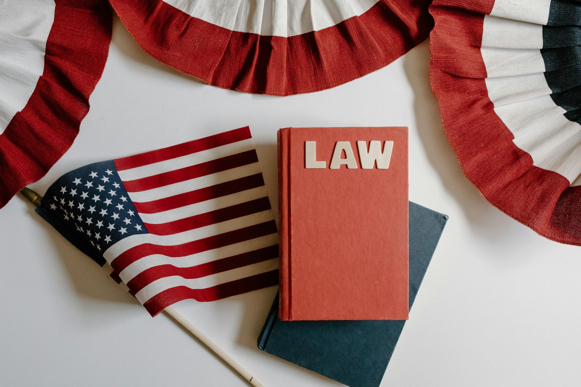 American flag, books, and patriotic bunting; the word