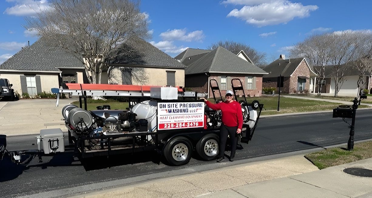 Man standing next to a service truck parked on a street in a suburban neighborhood.