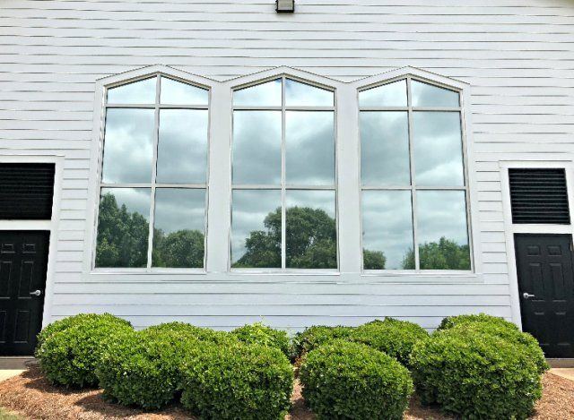 Professionally Fast Tinted Glass AL — White Wall With Tinted Glass Window in Montgomery, AL