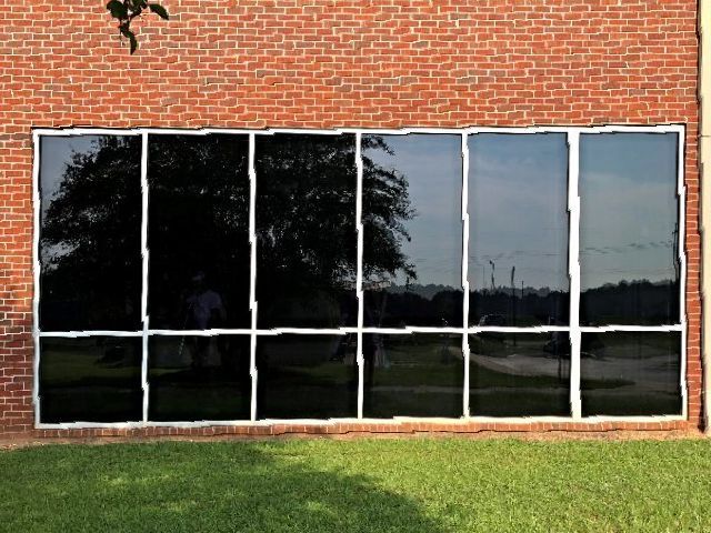 Residential Tinting Tallassee — Tinted Glass Window in Brick Wall Building in Montgomery, AL