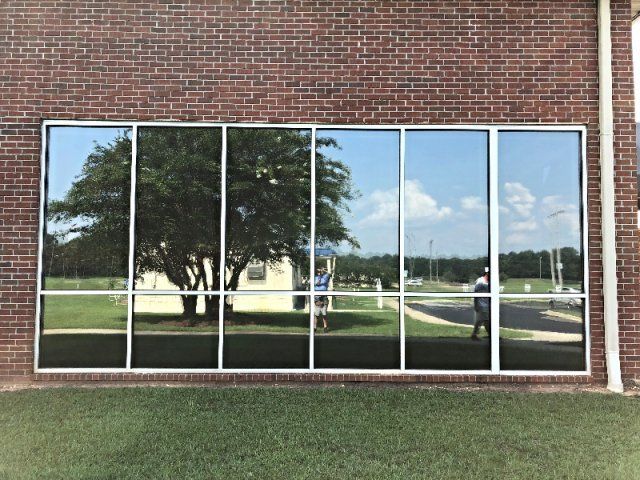 Commercial Tint Tallassee — Brick Wall Building With Tinted Big Window in Tallassee, AL