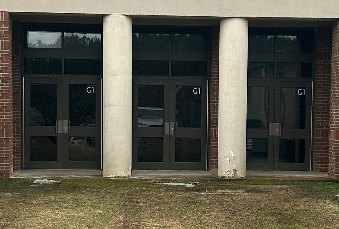 The school Gymnasium had issues inside where bright Sun glare caused  disruptions and limited team effectiveness prior to SPF Tinting services in Lee County, Alabama.