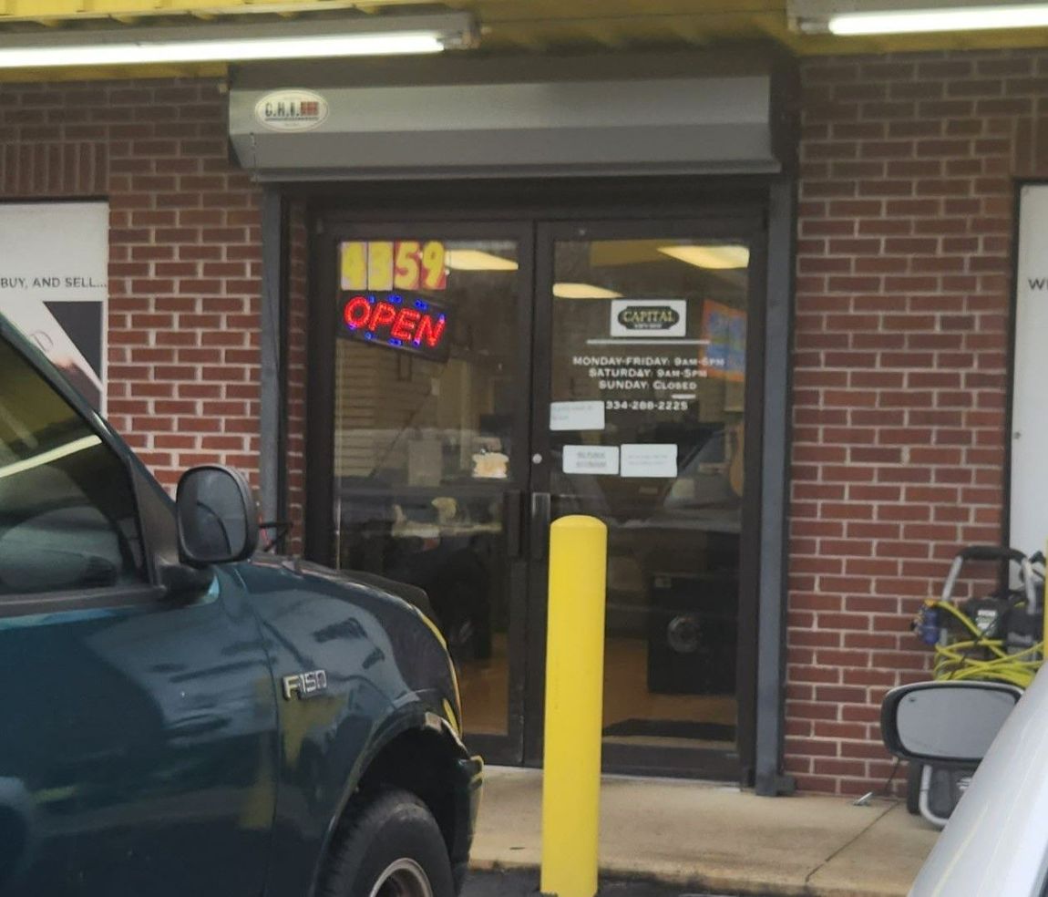 storefront window treatment - Bright Glare was reduced inside the storefront glass doors at Capital Pawn with SPF Tinting service in Montgomery AL