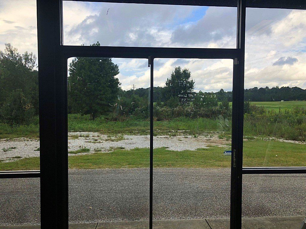 Looking out business windows before tint was installed in Auburn, AL