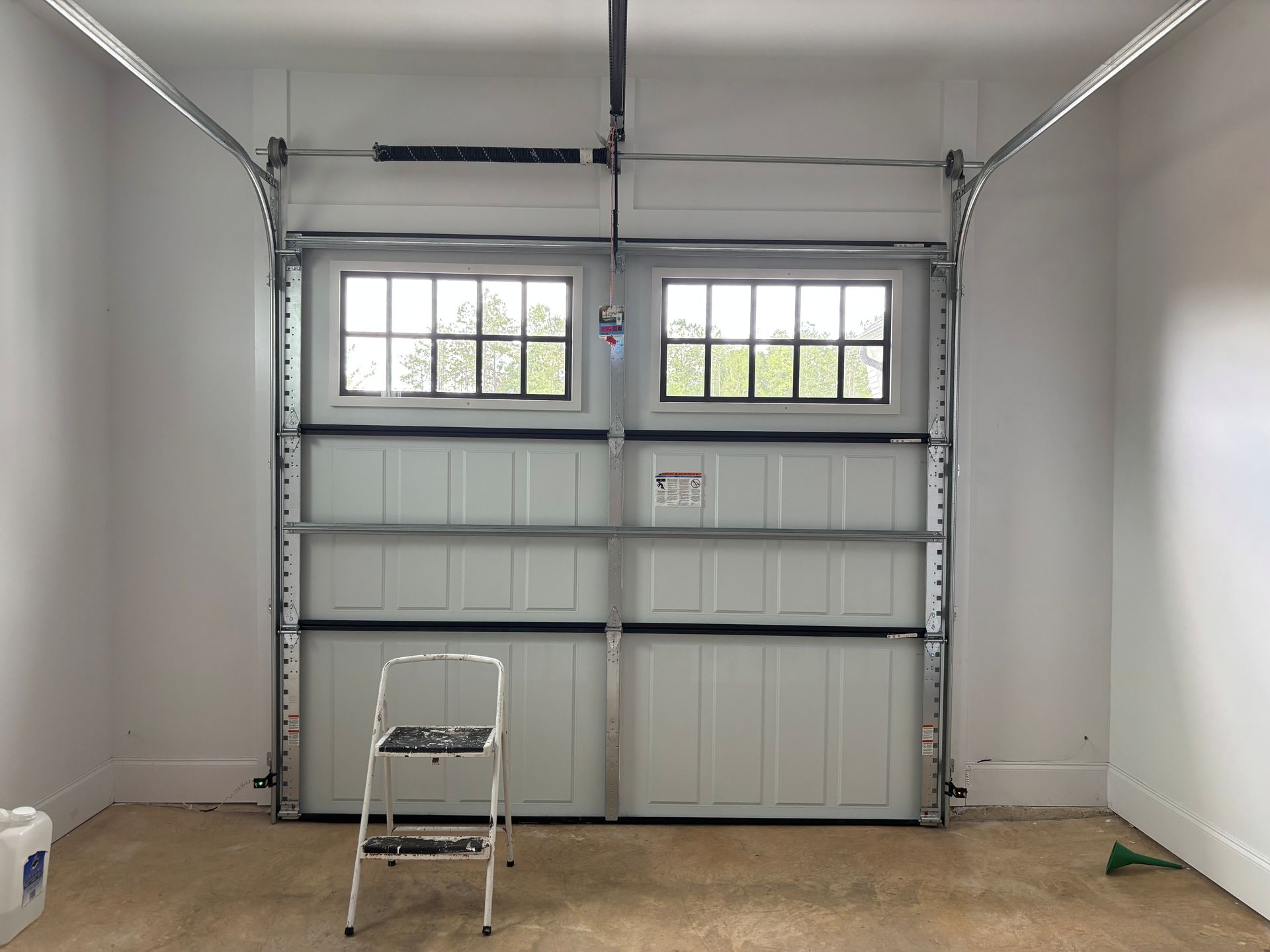 residential tinting Opelika - before SPF window tint blocks heat with sun glare entering home garage door windows in Opelika AL